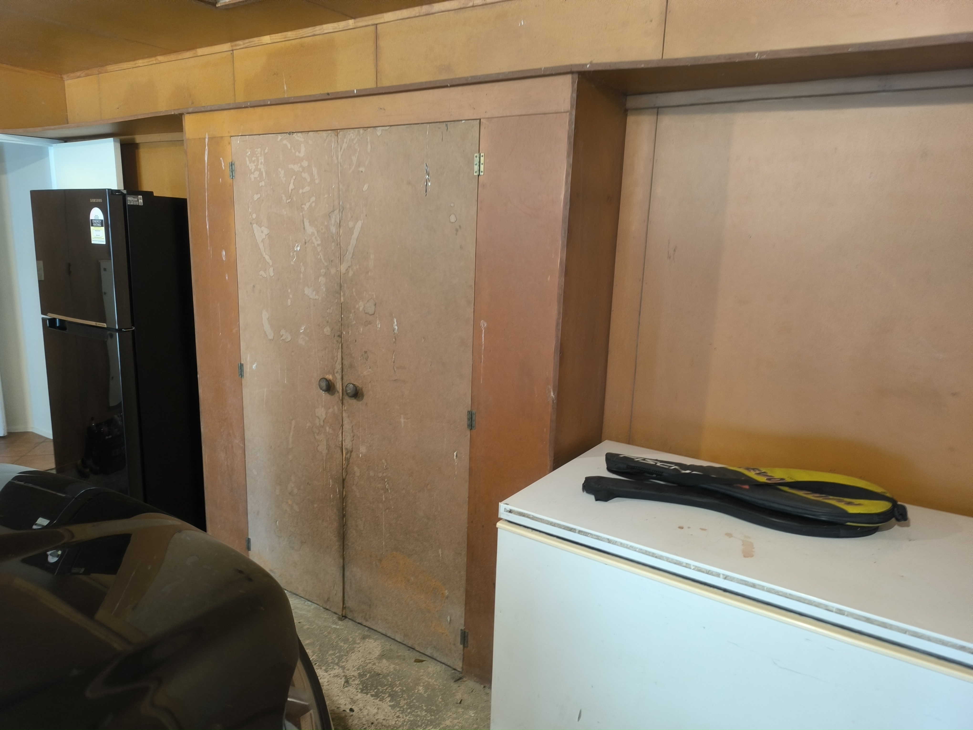 Garage wall before custom storage cabinetry